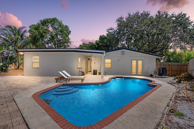 1517 NW 12th Ave, Fort Lauderdale, FL 33311 - pool at dusk with french doors and a patio