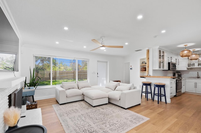 1517 NW 12th Ave, Fort Lauderdale, FL 33311 - living area featuring crown molding, plenty of natural light, light wood finished floors, ceiling fan, and a brick fireplace
