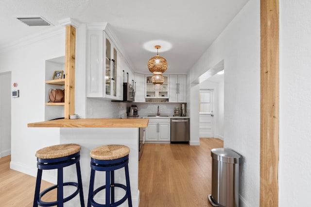 1517 NW 12th Ave, Fort Lauderdale, FL 33311 - kitchen with wood counters, open shelves, a sink, light wood-style flooring, and crown molding