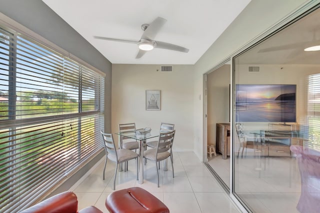 5876 Regal Glen Dr Unit 103, Boynton Beach, FL 33437 - dining area featuring plenty of natural light, a ceiling fan, light tile patterned flooring, and baseboards