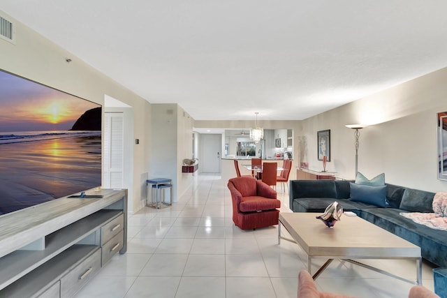 5876 Regal Glen Dr Unit 103, Boynton Beach, FL 33437 - living area featuring light tile patterned floors and a chandelier