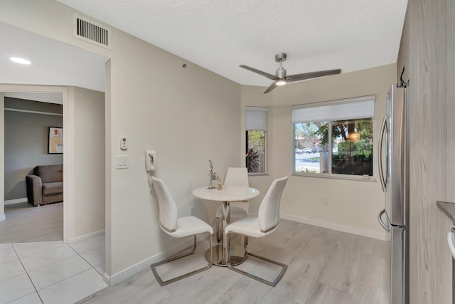 5876 Regal Glen Dr Unit 103, Boynton Beach, FL 33437 - dining room with light wood-style floors, ceiling fan, baseboards, and a textured ceiling