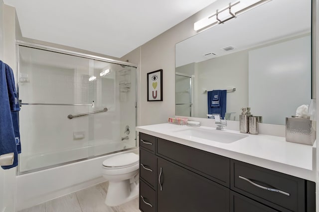 5876 Regal Glen Dr Unit 103, Boynton Beach, FL 33437 - bathroom with vanity, toilet, and bath / shower combo with glass door