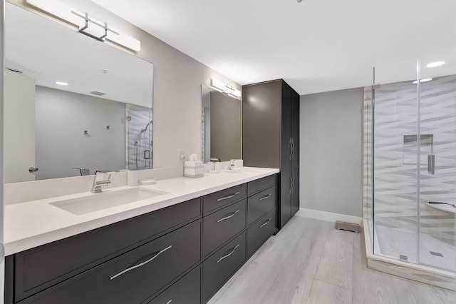 5876 Regal Glen Dr Unit 103, Boynton Beach, FL 33437 - full bath with double vanity, a stall shower, wood finished floors, baseboards, and recessed lighting
