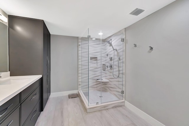 5876 Regal Glen Dr Unit 103, Boynton Beach, FL 33437 - bathroom with vanity, baseboards, a shower stall, recessed lighting, and wood finished floors