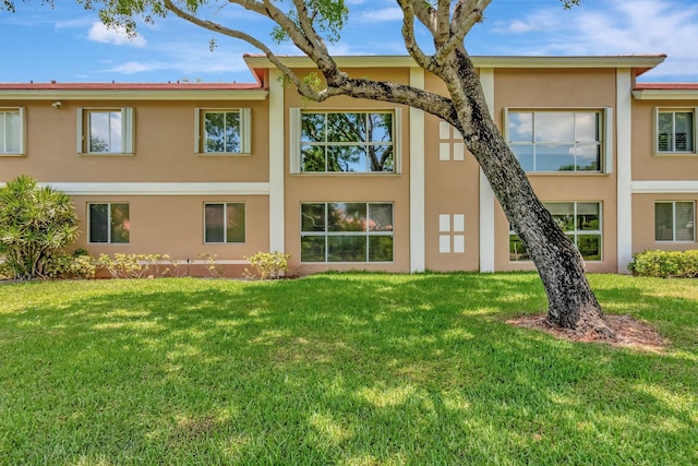 5876 Regal Glen Dr Unit 103, Boynton Beach, FL 33437 - back of property featuring stucco siding and a yard