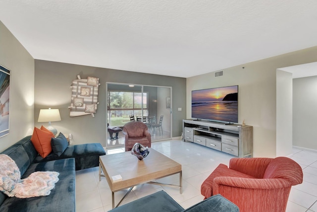 5876 Regal Glen Dr Unit 103, Boynton Beach, FL 33437 - living area featuring light tile patterned floors, baseboards, and a textured ceiling