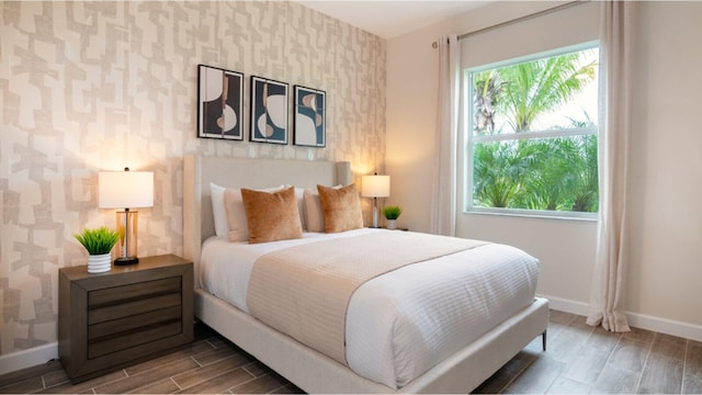 1169 SE Crosswood Way, Port Saint Lucie, FL 34984 - bedroom with wallpapered walls, baseboards, and wood finished floors