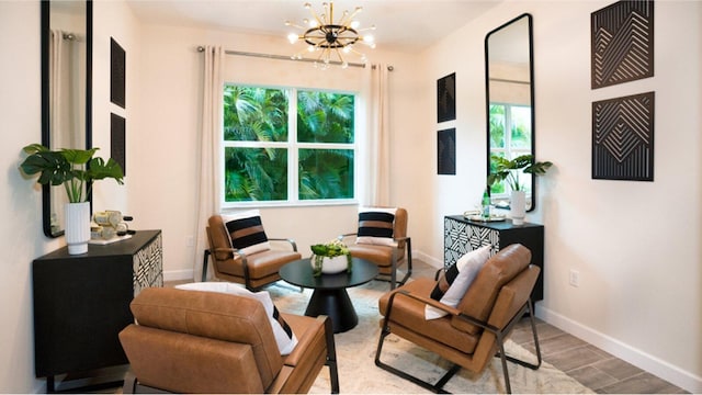 1169 SE Crosswood Way, Port Saint Lucie, FL 34984 - sitting room with a chandelier, baseboards, and wood finished floors
