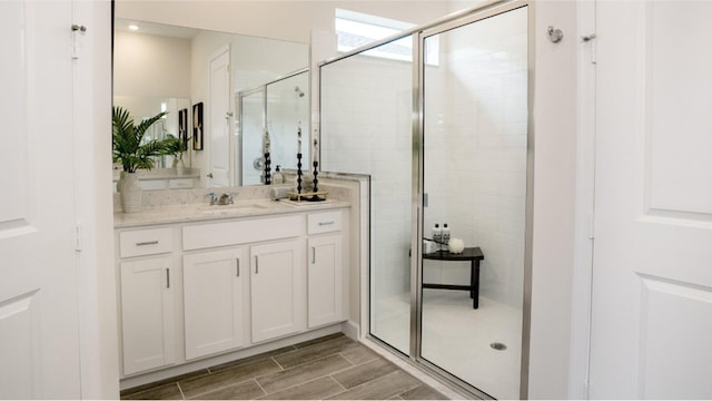 1169 SE Crosswood Way, Port Saint Lucie, FL 34984 - bathroom featuring a stall shower, vanity, and wood finished floors