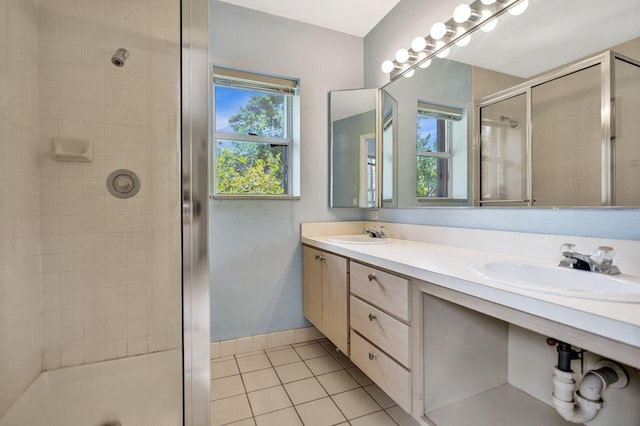8155 Chelsea Ct Unit 55A, West Palm Beach, FL 33406 - bathroom with a shower stall, double vanity, tile patterned flooring, and baseboards
