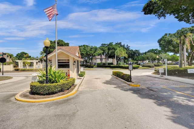 8155 Chelsea Ct Unit 55A, West Palm Beach, FL 33406 - view of asphalt street with street lights, traffic signs, curbs, and sidewalks