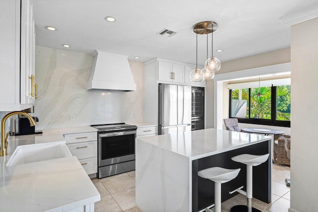 10739 Quail Covey Rd Azalea, Unit Azalea, Boynton Beach, FL 33436 - kitchen featuring stainless steel appliances, custom exhaust hood, a sink, tasteful backsplash, and a center island
