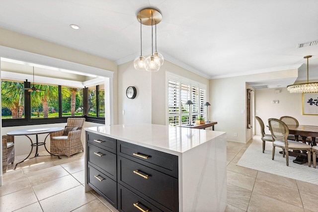 10739 Quail Covey Rd Azalea, Unit Azalea, Boynton Beach, FL 33436 - kitchen featuring crown molding, light countertops, light tile patterned flooring, dark cabinetry, and pendant lighting