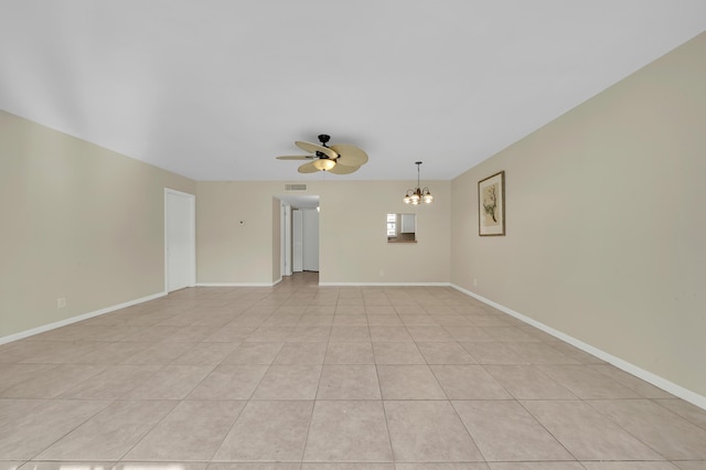719 Lori Dr Unit 102, Palm Springs, FL 33461 - empty room featuring a chandelier, a ceiling fan, baseboards, and light tile patterned flooring