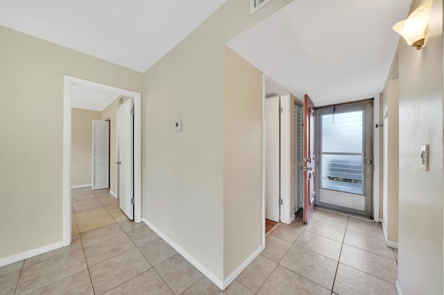 719 Lori Dr Unit 102, Palm Springs, FL 33461 - hallway featuring light tile patterned floors and baseboards