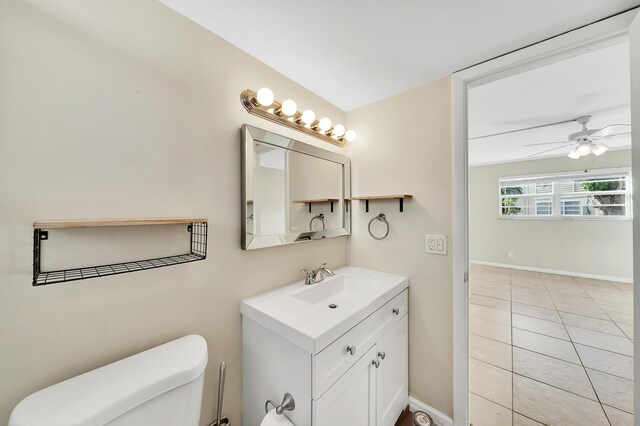 719 Lori Dr Unit 102, Palm Springs, FL 33461 - bathroom featuring toilet, ceiling fan, vanity, tile patterned flooring, and baseboards