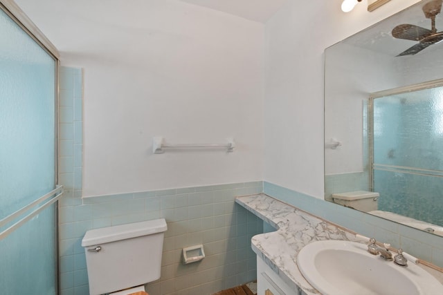 22602 SW 54th Way, Boca Raton, FL 33433 - full bath with toilet, tile walls, a wainscoted wall, a shower with shower door, and vanity