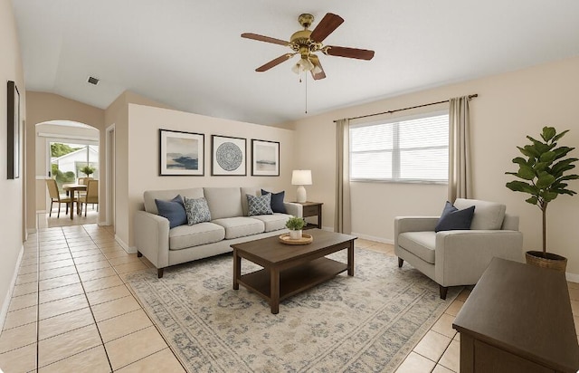 5618 Kingsmill Ct, Greenacres, FL 33463 - living room with light tile patterned floors, ceiling fan, plenty of natural light, vaulted ceiling, and arched walkways