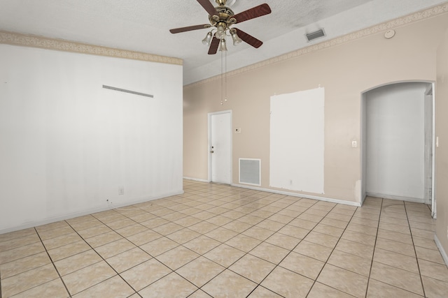 5618 Kingsmill Ct, Greenacres, FL 33463 - spare room featuring a ceiling fan, arched walkways, a textured ceiling, light tile patterned flooring, and baseboards