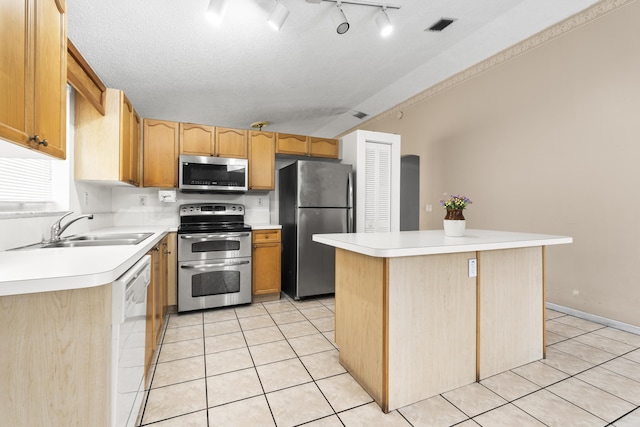 5618 Kingsmill Ct, Greenacres, FL 33463 - kitchen with stainless steel appliances, a sink, light tile patterned floors, light countertops, and a center island