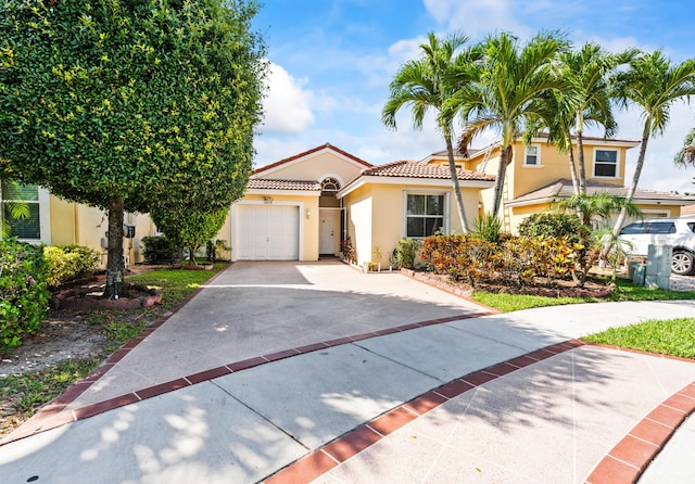 5618 Kingsmill Ct, Greenacres, FL 33463 - mediterranean / spanish-style home featuring stucco siding, a tiled roof, concrete driveway, and a garage