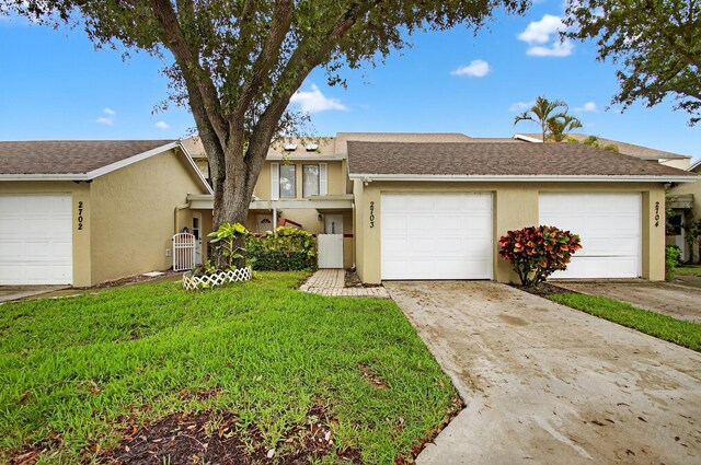 2703 Maplewood Dr, Greenacres, FL 33415 - kitchen featuring stainless steel appliances, a sink, cream cabinetry, dark countertops, and decorative backsplash