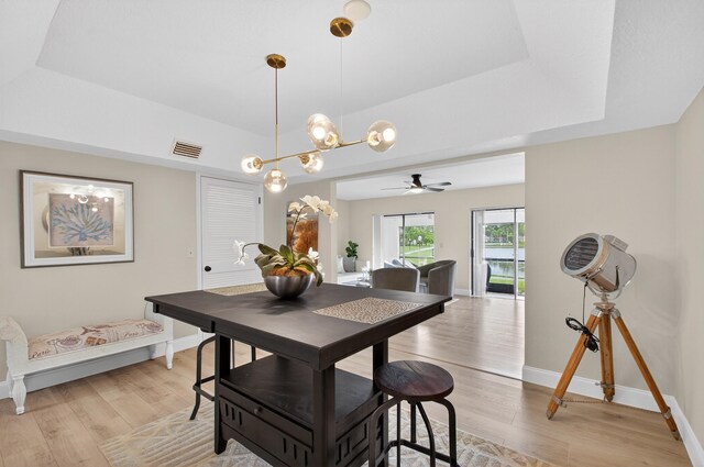 2703 Maplewood Dr, Greenacres, FL 33415 - dining space with a raised ceiling, light wood finished floors, baseboards, and a ceiling fan