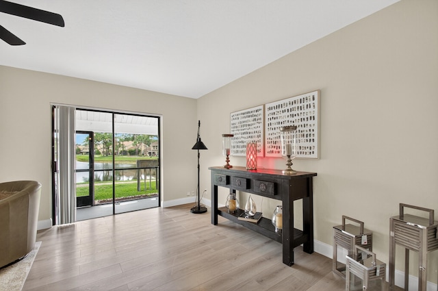 2703 Maplewood Dr, Greenacres, FL 33415 - interior space featuring a ceiling fan, baseboards, wood finished floors, and a water view