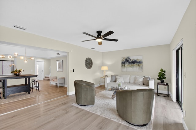 2703 Maplewood Dr, Greenacres, FL 33415 - living area with light wood-style floors, a ceiling fan, and baseboards