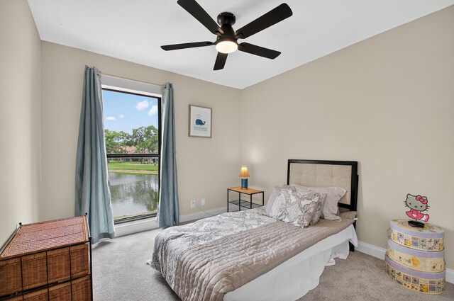2703 Maplewood Dr, Greenacres, FL 33415 - carpeted bedroom with baseboards, ceiling fan, and a water view