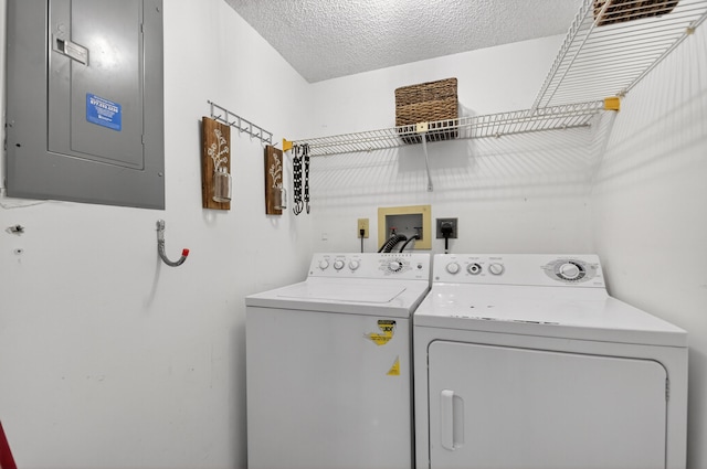 2703 Maplewood Dr, Greenacres, FL 33415 - laundry room featuring electric panel, separate washer and dryer, and a textured ceiling