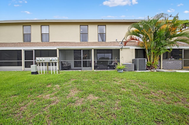 2703 Maplewood Dr, Greenacres, FL 33415 - rear view of house with a sunroom, stucco siding, central AC unit, and a yard