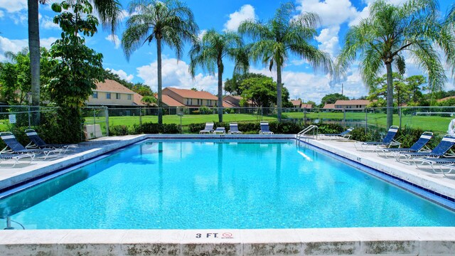 2703 Maplewood Dr, Greenacres, FL 33415 - community pool featuring a residential view and a patio area