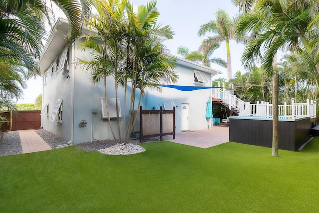 1809 Surfside Dr, Fort Pierce, FL 34949 - rear view of house featuring stucco siding, stairs, a patio, and a gate