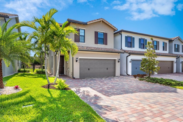 4858 Blistering Way, Lake Worth, FL 33467 - townhome / multi-family property featuring a garage, stucco siding, decorative driveway, a front yard, and a tile roof