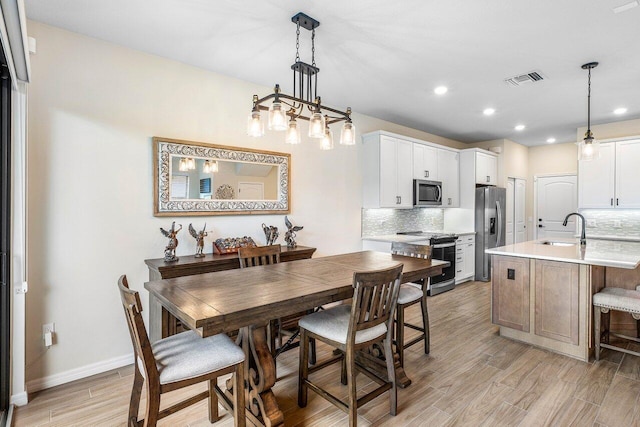 4858 Blistering Way, Lake Worth, FL 33467 - dining space with light wood finished floors, recessed lighting, and baseboards
