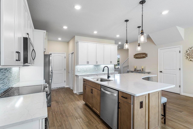 4858 Blistering Way, Lake Worth, FL 33467 - kitchen with stainless steel appliances, a sink, backsplash, a kitchen island with sink, and recessed lighting
