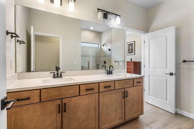 4858 Blistering Way, Lake Worth, FL 33467 - full bath with double vanity, a shower stall, wood finish floors, and baseboards