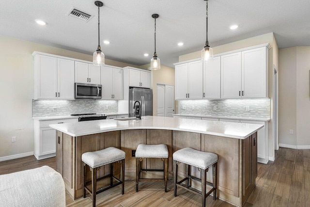 4858 Blistering Way, Lake Worth, FL 33467 - kitchen featuring stainless steel appliances, tasteful backsplash, dark wood-style flooring, and recessed lighting