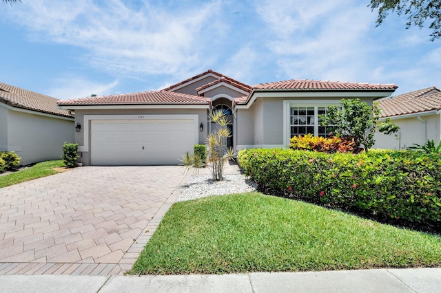 6563 Kings Creek Ter, Boynton Beach, FL 33437 - mediterranean / spanish-style house with stucco siding, decorative driveway, a garage, a tile roof, and a front yard