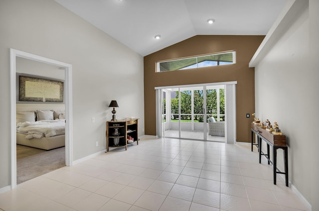 6563 Kings Creek Ter, Boynton Beach, FL 33437 - living room with high vaulted ceiling, light tile patterned flooring, baseboards, and light carpet