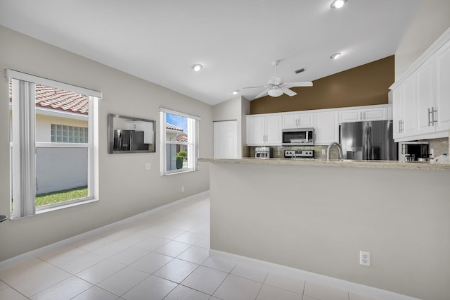 6563 Kings Creek Ter, Boynton Beach, FL 33437 - kitchen featuring stainless steel appliances, vaulted ceiling, decorative backsplash, a ceiling fan, and white cabinetry