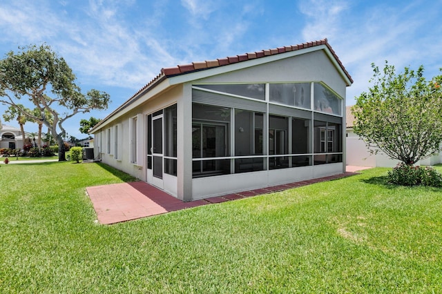 6563 Kings Creek Ter, Boynton Beach, FL 33437 - back of property with a sunroom, central AC unit, a yard, and a tile roof