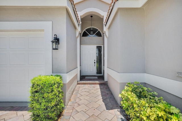 6563 Kings Creek Ter, Boynton Beach, FL 33437 - doorway to property with stucco siding and an attached garage