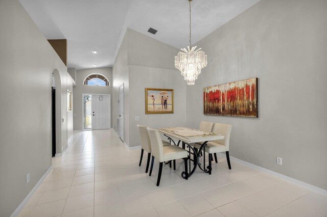 6563 Kings Creek Ter, Boynton Beach, FL 33437 - dining area with high vaulted ceiling, arched walkways, a chandelier, light tile patterned floors, and baseboards