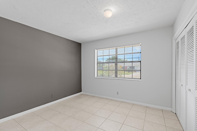 453 NE 38th St, Boca Raton, FL 33431 - unfurnished bedroom with a closet, a textured ceiling, and baseboards