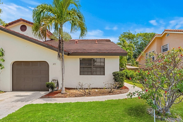 453 NE 38th St, Boca Raton, FL 33431 - view of front of home with a garage, stucco siding, concrete driveway, a front yard, and a tiled roof