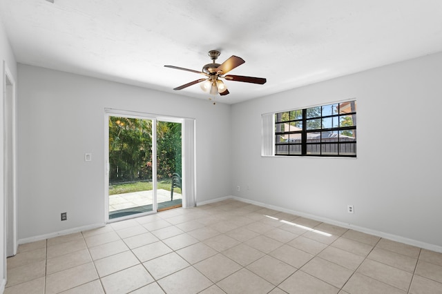 453 NE 38th St, Boca Raton, FL 33431 - unfurnished room featuring plenty of natural light, ceiling fan, baseboards, and light tile patterned flooring