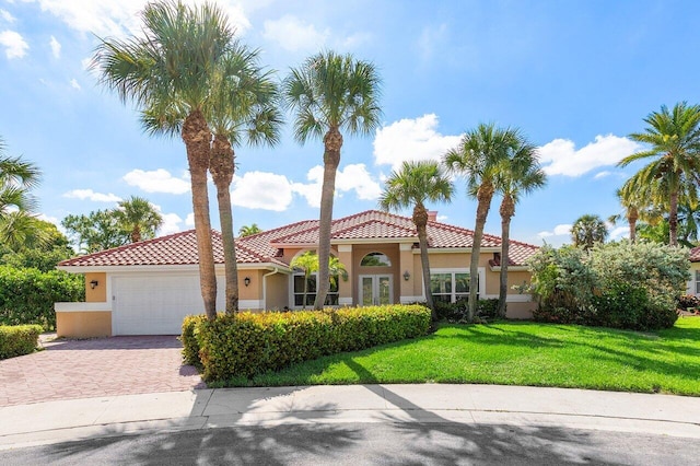 1345 SW 21st Ave, Boca Raton, FL 33486 - mediterranean / spanish-style house with stucco siding, decorative driveway, a front yard, an attached garage, and a tiled roof